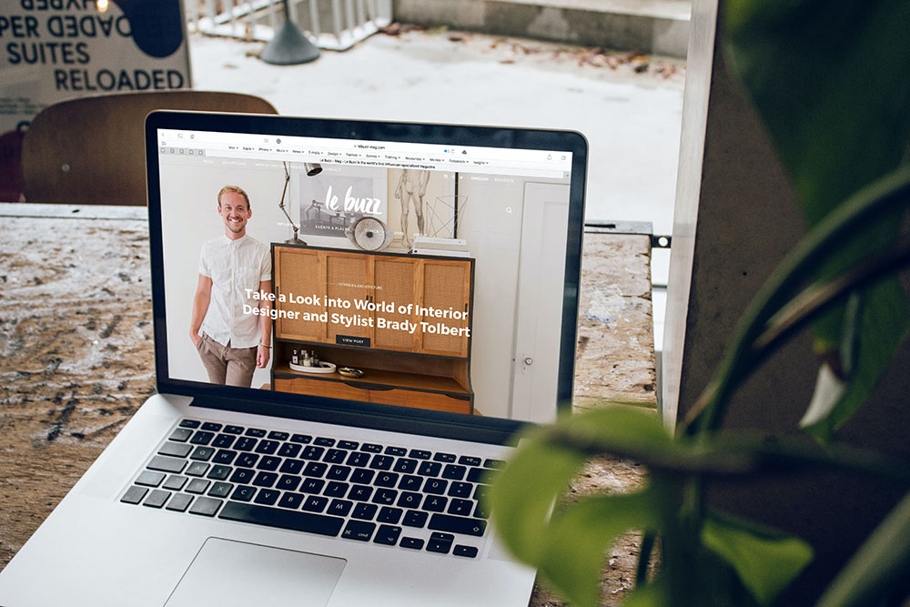 laptop on a table showing a man standing beside a cupboard